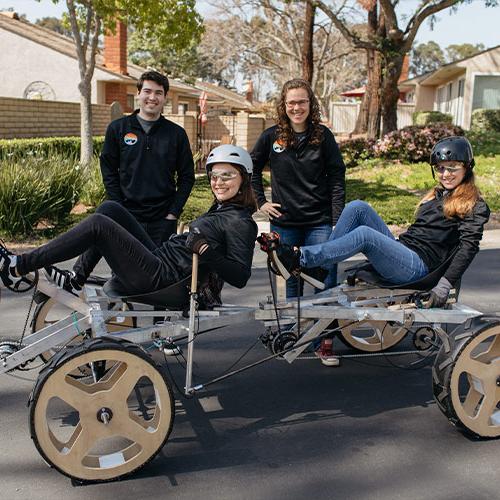 Students posing with the rover